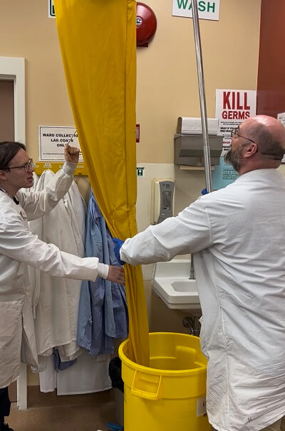 Connor and a member of the lab team test the emergency shower.